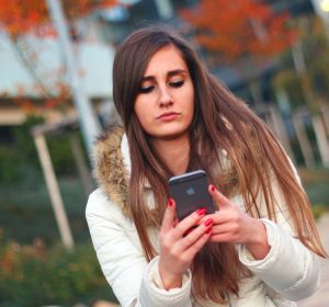 Una adolescente mira el móvil Una adolescente mira el móvil