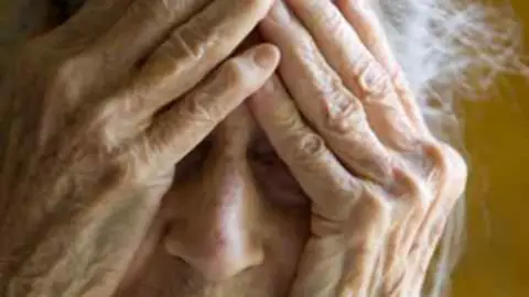 Una mujer tapándose la cara con las manos Una mujer tapándose la cara con las manos