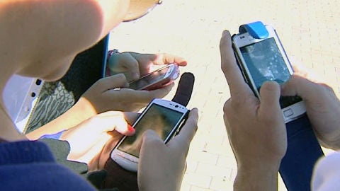 J&oacute;venes con su m&oacute;vil