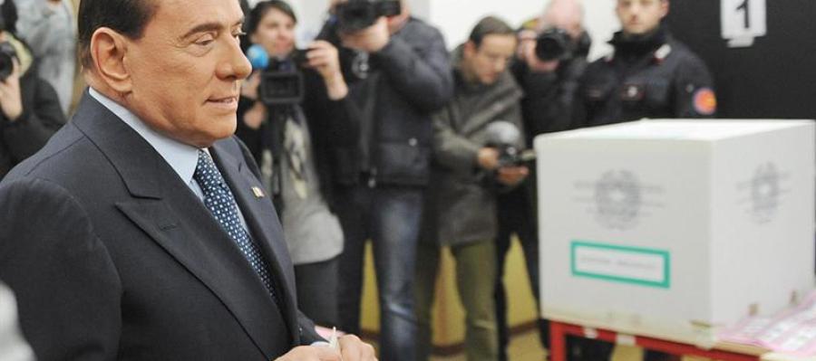 Berlusconi inserta su voto en urna urna electoral. Berlusconi inserta su voto en urna urna electoral.