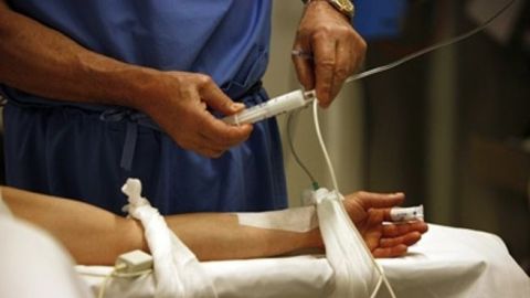 Un sanitario administra f&aacute;rmacos a un paciente.