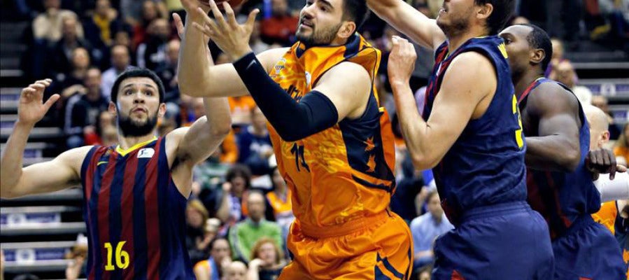 El ala pivot del Valencia Basket Bojan Dubljevic intenta superar la defensa del alero del Barcelona Bostjan Nachbar y del alero griego Kostas Papanikolau El ala pivot del Valencia Basket Bojan Dubljevic intenta superar la defensa del alero del Barcelona Bostjan Nachbar y del alero griego Kostas Papanikolau