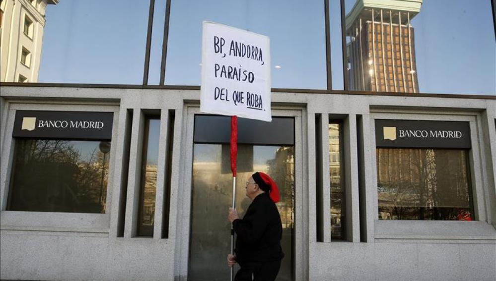 Un hombre protesta ante la sede del Banco de Madrid