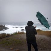 Un hombre ve cómo el viento le dobla el paraguas en A Coruña