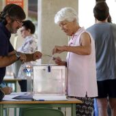 Una mujer deposita su voto en una urna de un colegio electoral