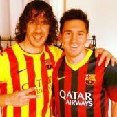 Carles Puyol junto a Leo Messi