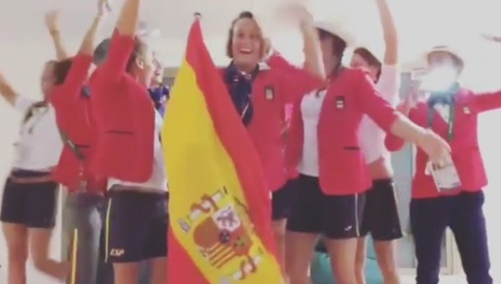 Mireia Belmonte porta la bandera de España junto al equipo de natación en la Villa