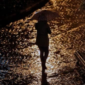 Joven con paragüas bajo la lluvia Joven con paragüas bajo la lluvia