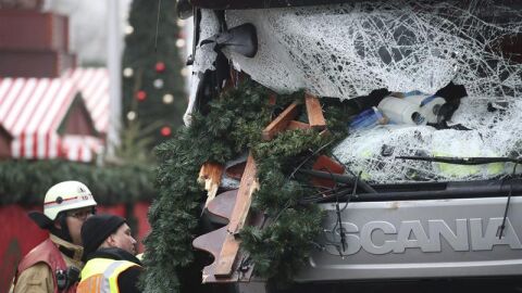 n polic&iacute;a y un bombero inspeccionan el cami&oacute;n del atentado en Berl&iacute;n