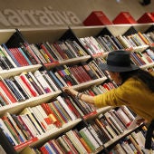 Una mujer mira libros en los estanterías de una librería