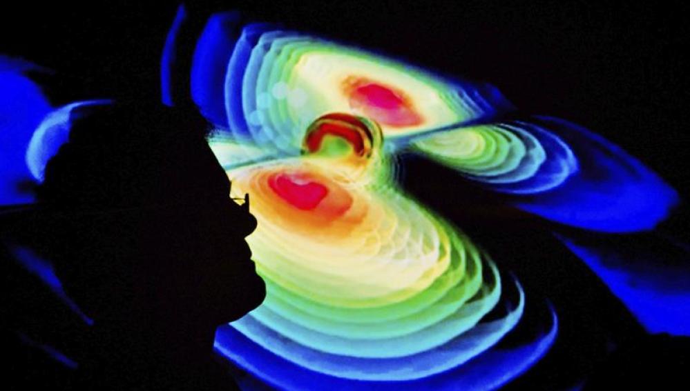Un científico observa una representación de las ondas gravitacionales 