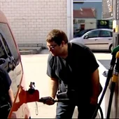 Un vehículo repone combustible en una gasolinera Un vehículo repone combustible en una gasolinera