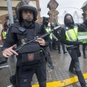 Agentes antidisturbios de la Policía Nacional retiran material