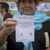 Una mujer muestra una papeleta del referéndum del 1-O 