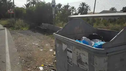 Contenedor de basura sin tapa junto a la parada de autobuses del Camí del Bolo de Elche Contenedor de basura sin tapa junto a la parada de autobuses del Camí del Bolo de Elche