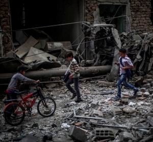 Niños sirios observan los daños ocasionados tras un bombardeo a las afueras de Damasco Niños sirios observan los daños ocasionados tras un bombardeo a las afueras de Damasco