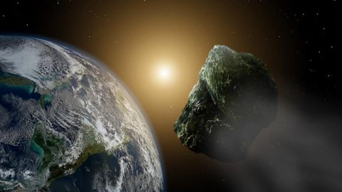 Recreaci&oacute;n art&iacute;stica de un asteroide pasando por las cercan&iacute;as de nuestro planeta