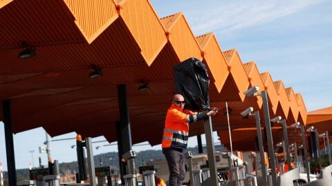 Operarios de autopistas trabajan en quitar las bolsas en las c&aacute;maras del peaje de la autopista AP-7 