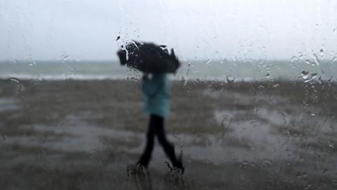Un hombre se protege de la lluvia