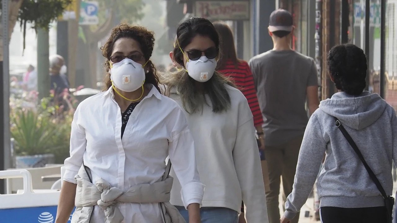 Personas caminando con mascarillas en Oakland, California