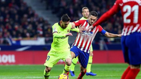Koke pelea un bal&oacute;n ante Messi