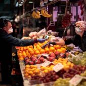 Una persona compra en un puesto de frutas del Mercado Central de Valencia