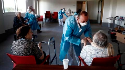 Un sanitario atiende a los ancianos alojados en una residencia