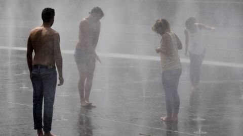 Varias personas se refrescan en una fuente de Madrid R&iacute;o debido a las altas temperaturas del verano de 2015. / EFE/Javier Liz&oacute;n
