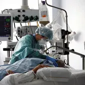 Una médico trata a un paciente de COVID-19 en una UCI. Una médico trata a un paciente de COVID-19 en una UCI.