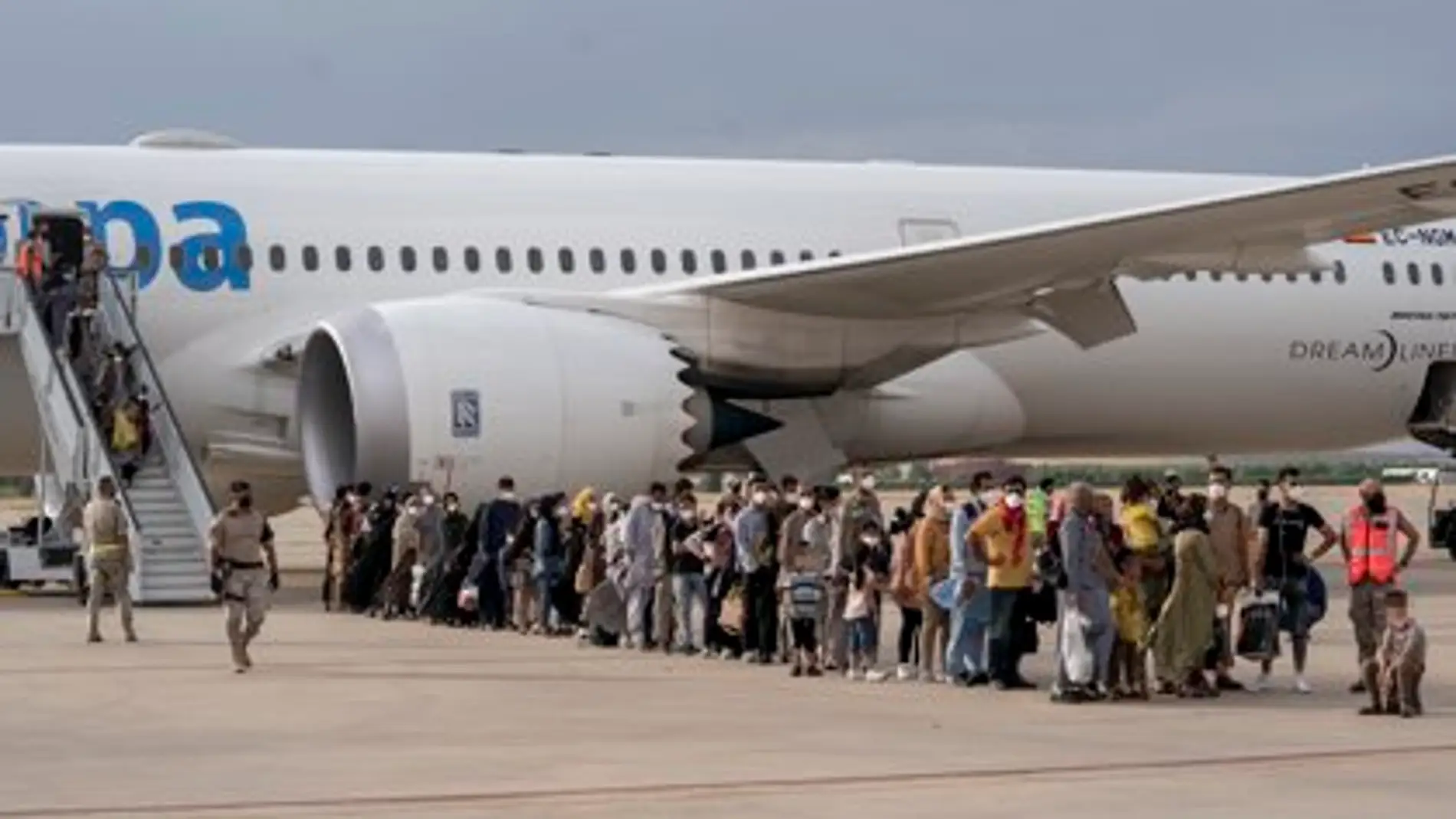 Un grupo de refugiados tras la llegada de un nuevo avión con 260 personas procedentes de Afganistán, en la base aérea de Torrejón de Ardoz
