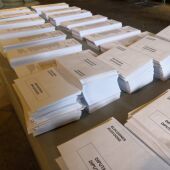 Papeletas y sobres en una mesa ubicada en un colegio electoral