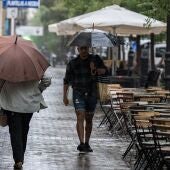 Varias personas se resguardan de la lluvia durante la DANA en Madrid