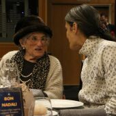 Una voluntaria de la asociación 'Amics de la Gent Gran' con una usuaria en la cena de Navidad de este año