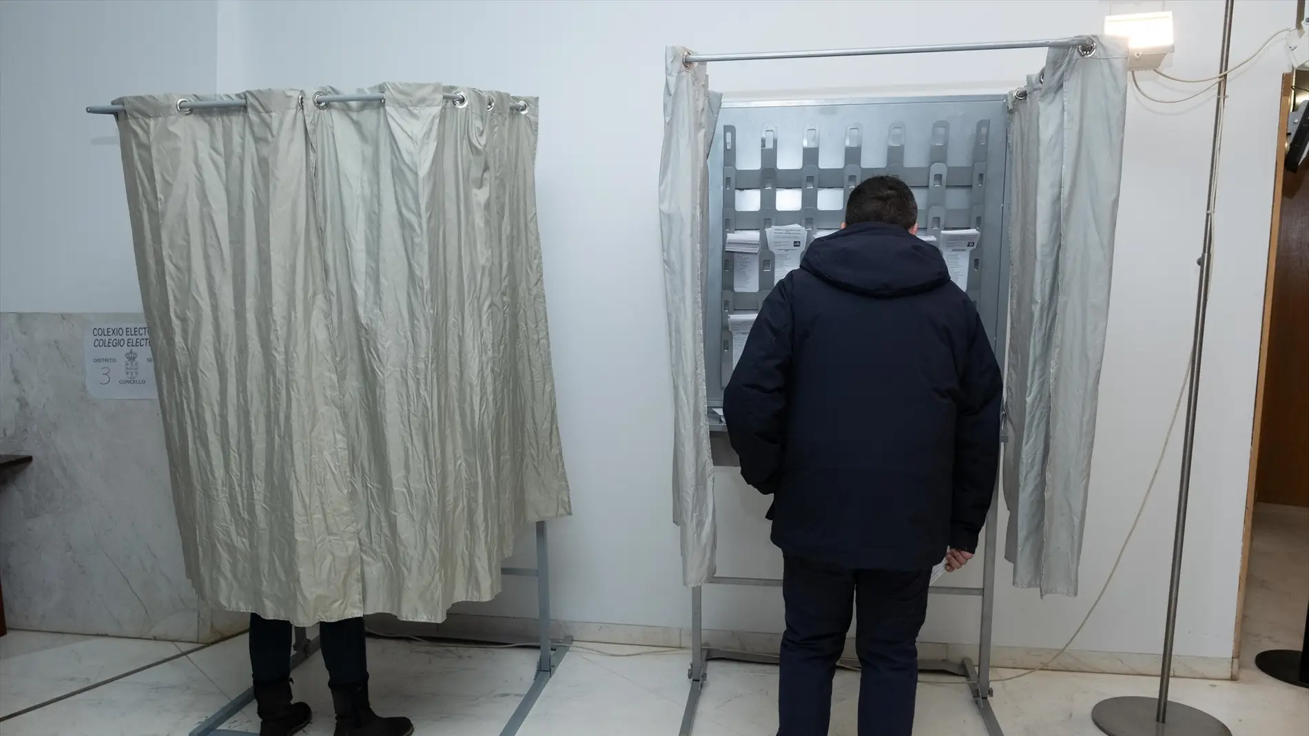 Imagen de ciudadanos eligiendo su voto en un colegio electoral en Galicia