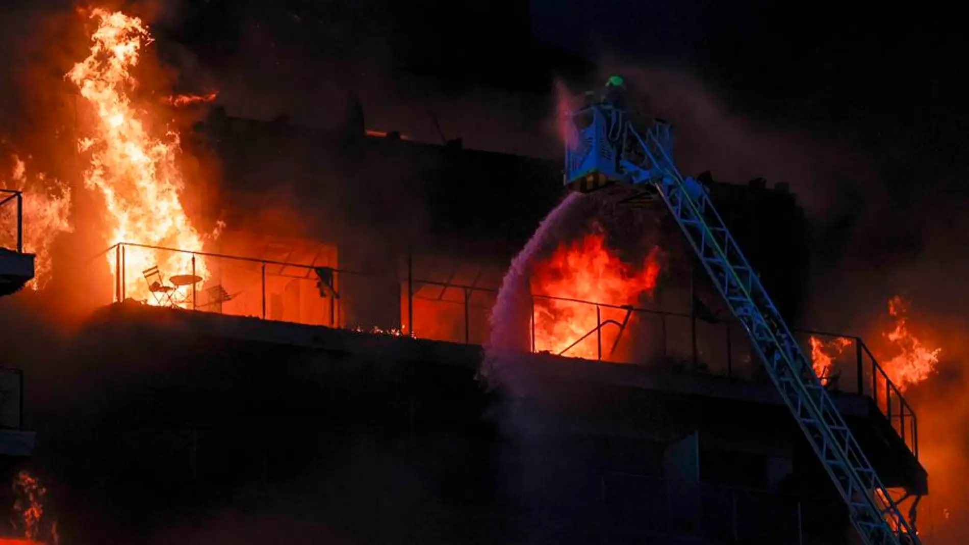 Tareas de extinción de las llamas en el incendio del complejo de viviendas del barrio valenciano de Campanar. 