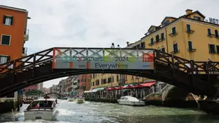 Uno de los canales de Venecia, con un cartel promocionando la Bienal 