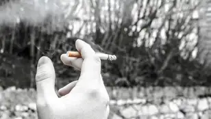 Un hombre fumando en la calle 