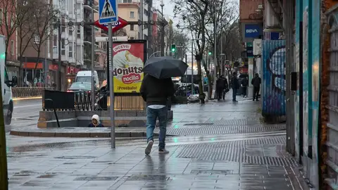 Imagen de archivo de un hombre protegido de la lluvia con un paraguas Imagen de archivo de un hombre protegido de la lluvia con un paraguas