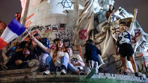 J&oacute;venes celebrando los resultados de las elecciones en Francia en la Plaza de la Rep&uacute;blica de Par&iacute;s/ EFE/EPA/YOAN VALAT