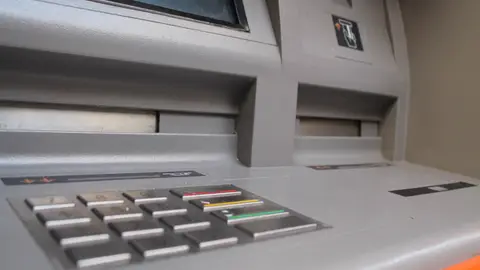 Foto de archivo de un cajero. Foto de archivo de un cajero.