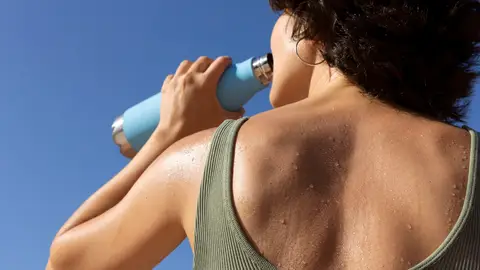 Mujer bebiendo agua al sol Mujer bebiendo agua al sol