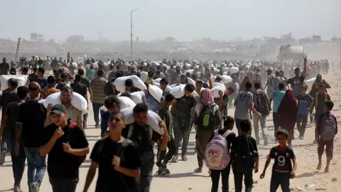 Miles de palestinos esperan para recibir ayuda. Miles de palestinos esperan para recibir ayuda.