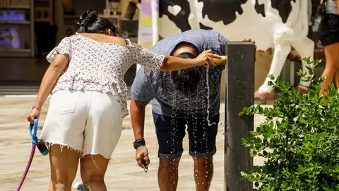 Un hombre se refresca en una fuente en Valencia Un hombre se refresca en una fuente en Valencia