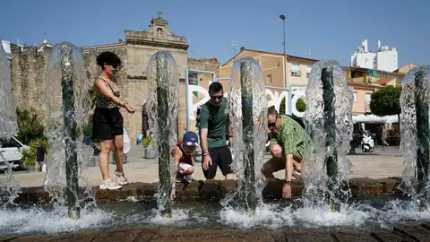 Una familia se refresca en una fuente en Plasencia. Una familia se refresca en una fuente en Plasencia.