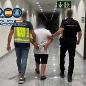 Agentes de la Policía Nacional con el detenido en el aeropuerto Alicante-Elche. Agentes de la Policía Nacional con el detenido en el aeropuerto Alicante-Elche.