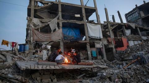 Palestinos desplazados se calientan junto a una hoguera entre las ruinas de su vivienda destruida en Jan Yunis, en el sur de la Franja de Gaza, el 30 de diciembre de 2025. Palestinos desplazados se calientan junto a una hoguera entre las ruinas de su vivienda destruida en Jan Yunis, en el sur de la Franja de Gaza, el 30 de diciembre de 2025.