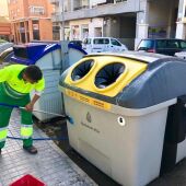 Un trabajador de la limpieza de Elche limpia un contenedor de envases.