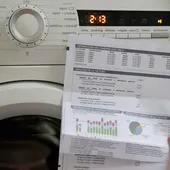 Imagen de archivo de una factura de electricidad de un hogar ante un electrodoméstico. Imagen de archivo de una factura de electricidad de un hogar ante un electrodoméstico.