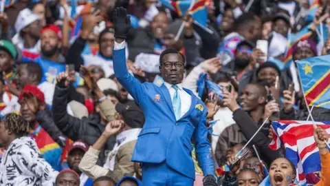 Lumumba Vea, el aficionado del Congo que se hizo viral por quedarse inmóvil con el brazo en alto durante 90 minutos Lumumba Vea, el aficionado del Congo que se hizo viral por quedarse inmóvil con el brazo en alto durante 90 minutos