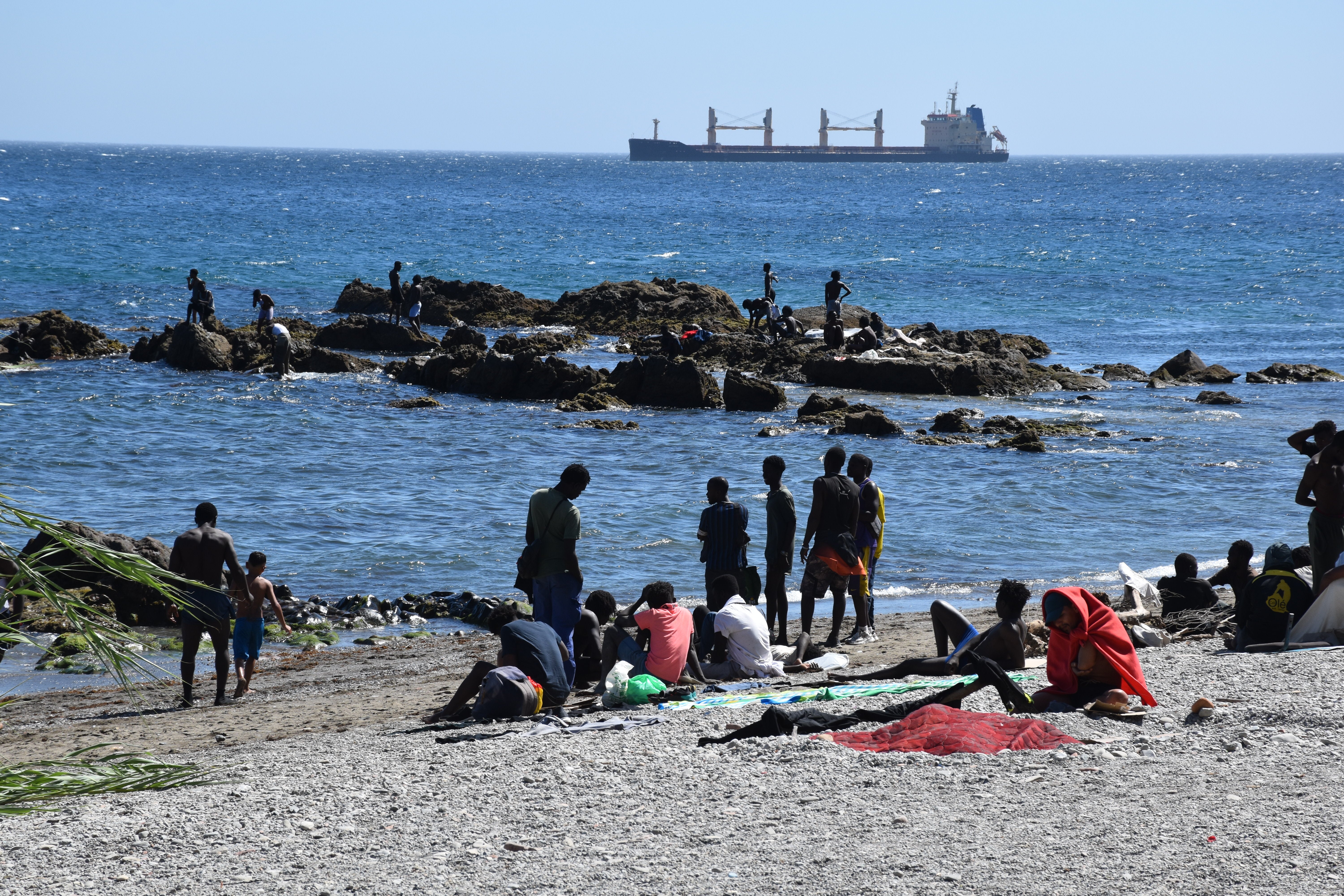 Several people on Trampolin beach, 5 August 2026, in Ceuta, Spain. The National Police have begun the process of screening the migrants currently in Ceuta – “around 2,500” according to information from the Government Delegation – following last week’s mass influx, with a view to either rejecting or granting their asylum applications. Several people on Trampolin beach, 5 August 2026, in Ceuta, Spain. The National Police have begun the process of screening the migrants currently in Ceuta – “around 2,500” according to information from the Government Delegation – following last week’s mass influx, with a view to either rejecting or granting their asylum applications.